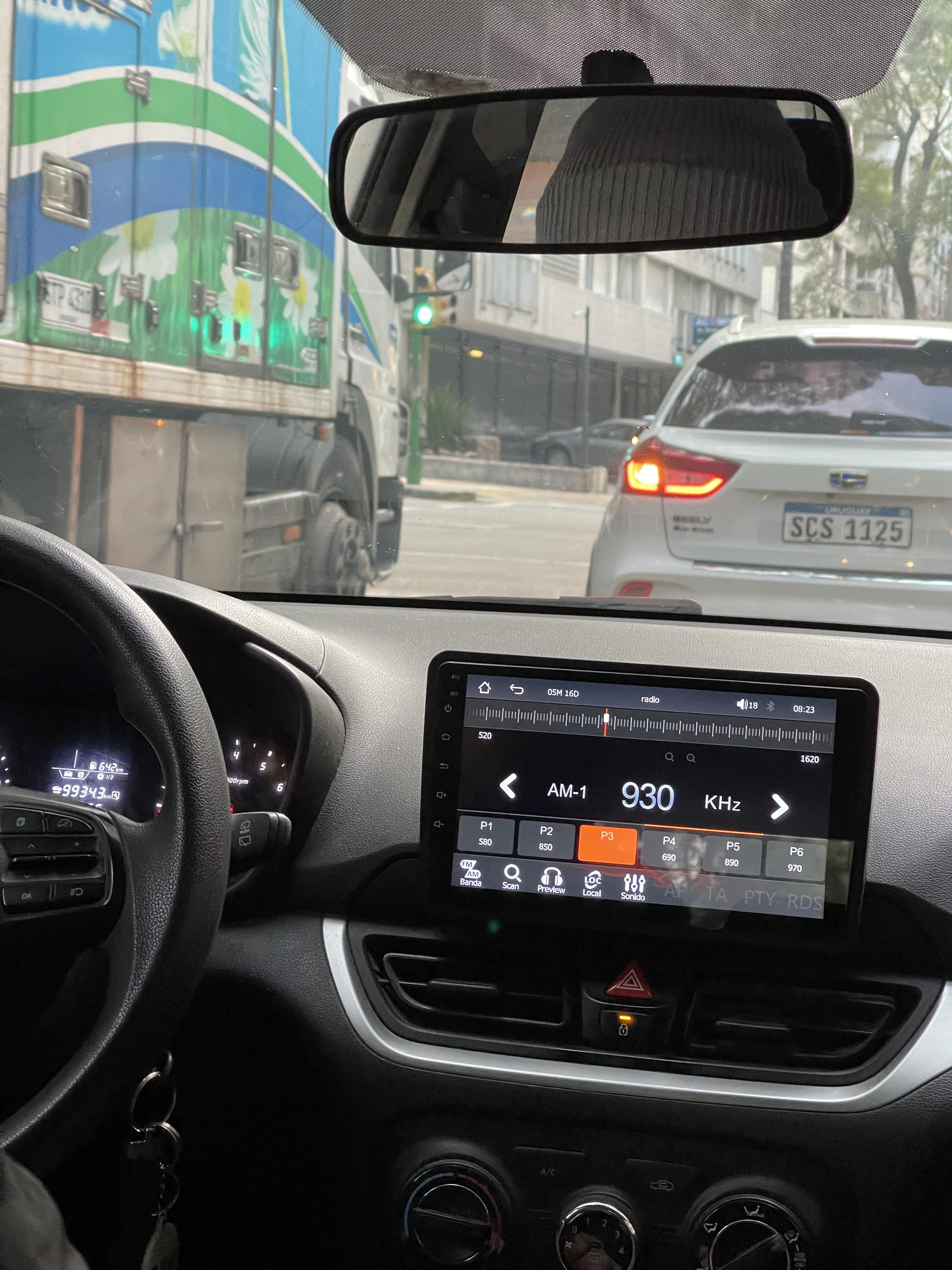 A radio app on a dashboard touchscreen, set to AM 930 KHz.